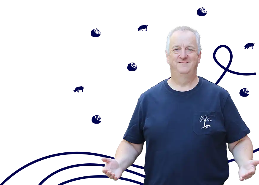 Ray Miles from Digypig standing in front of a white background with blue illustrations, wearing a navy blue t-shirt with a white tree and pig design on the left chest. Background illustrations include blue lines, swirls, and small pig and truffle figures. Ray is gesturing with outstretched arms, inviting you to come in as they are open.